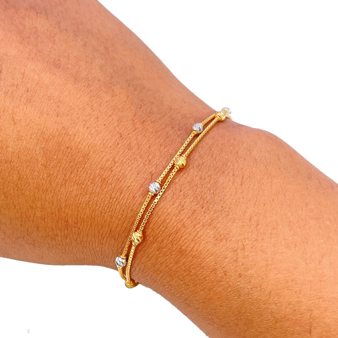 22-karaats geelgouden dubbele ketting met tweekleurige diamantgeslepen kralen armband